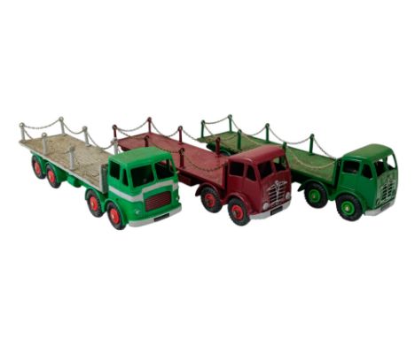 A Dinky Supertoys Foden flatbed truck - maroon, together with a similar later green example and a Layland Octopus. (3)