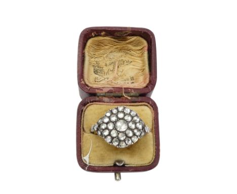 A late 19th century diamond set ring - the central stone set within bands of further stones in a circular setting with leaf s