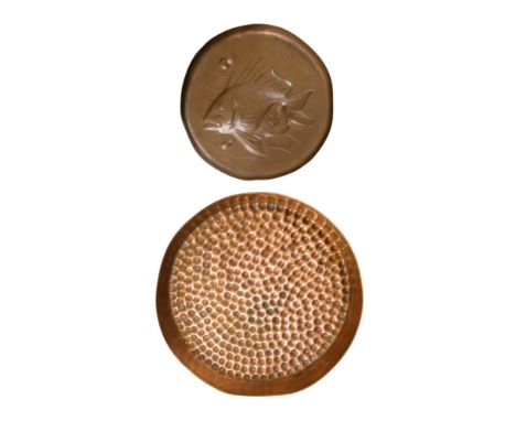 A late 19th century Newlyn copper dish - circular and repousse decorated with a fish, 9cm diam, together with another copper 