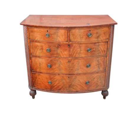 A George III mahogany bowfront chest of drawers - with an arrangement of two short and three long drawers flanked by spiral r