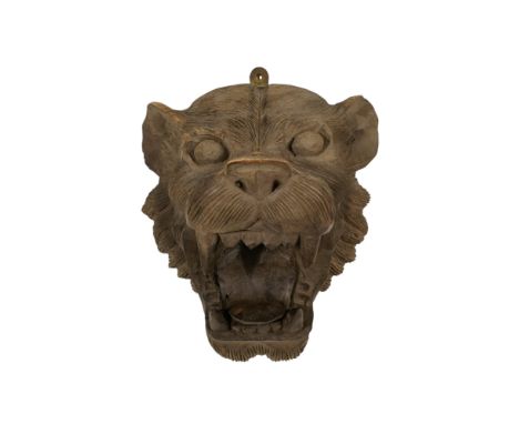 A carved hardwood mask - modelled in the form of a leopard, mouth agape, 25cm high.