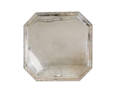 A silver tray - London 1935, square with canted corners and raised on lug feet, 1,052g.