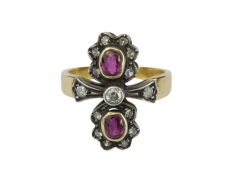 A late 19th century diamond and ruby set ring - with a double floral type setting on a yellow metal band marked as 18ct, size