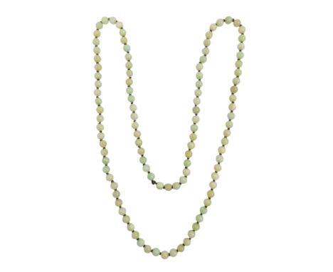 A jade necklace - of uniform beads, length 124cm.