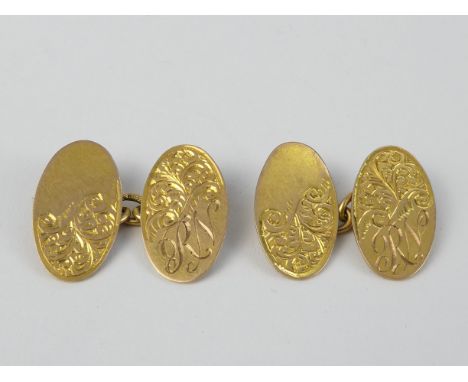 A pair of 9ct gold cufflinks - the oval buttons engraved with foliage and initials, 5.9g.