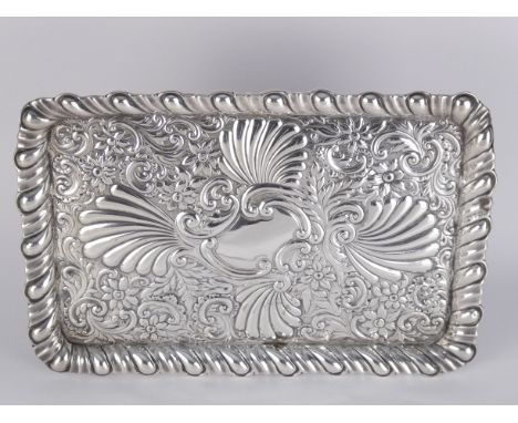 A rectangular silver dressing tray - with foliate repousse decoration, 336g.