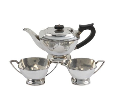 A three piece silver tea service - Sheffield 1964, of bowed rectangular form with ebonised fittings and raised on a foot, 842