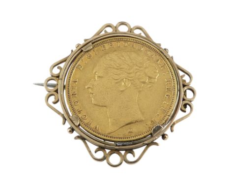 A Victorian sovereign - 1885, within a yellow metal brooch frame, 10.7g.
