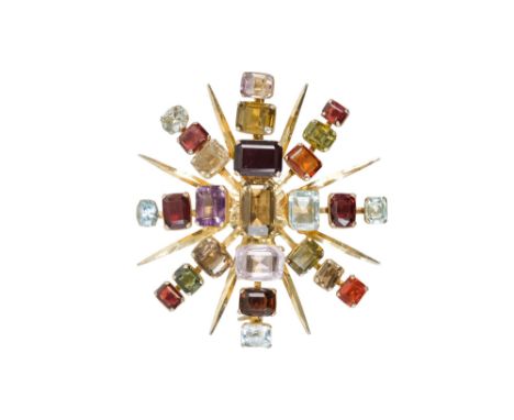 A gilt metal gem set star brooch - mounted with graduated rectangular stones.