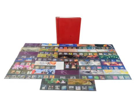 A Red stamp album with miscellaneous - mainly modern world stamps, 28 plus presentation packs, approx. face value £55.