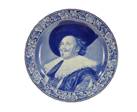 A 20th century Delft charger - decorated with an image of a cavalier within a foliate border, 41cm diameter.