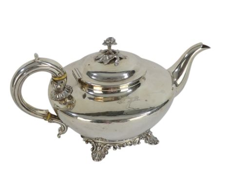 A silver teapot - London 1832, of squat circular form and decorated with armorial, raised on a circular leaf cast foot rim, 6