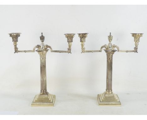 A pair of silver two branch candlesticks - Sheffield 1888, in the form of Corinthian columns on stepped bases, 36cm high. (2)