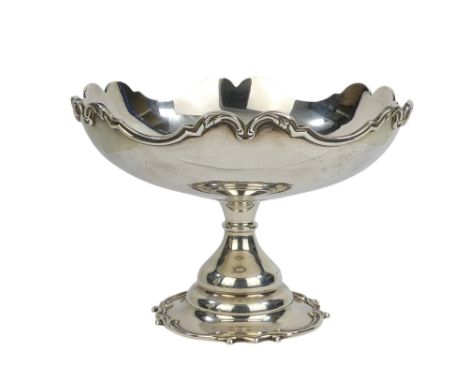 A silver pedestal fruit bowl - London 1903, with leaf cast ogee shaped rim.