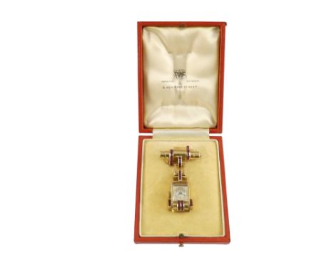 A vintage 9ct gold cased ladies fob watch - in the Art Deco style and set with rubies, the case hangs from a suspension clasp