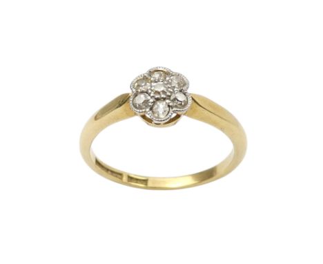 A 9ct gold diamond set ring - with a floral setting, size K, 2.2g.