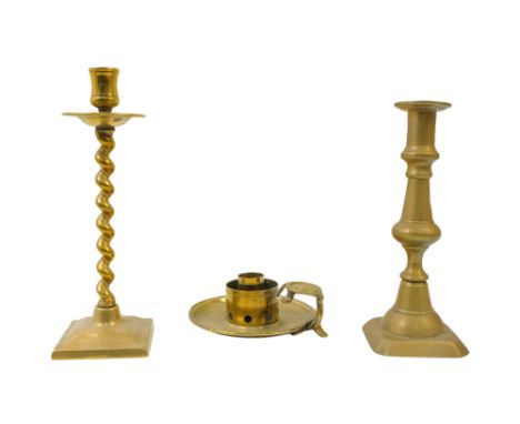 A 19th century brass candlestick - of baluster form with a square canted base, 20cm high, together with another candlestick a