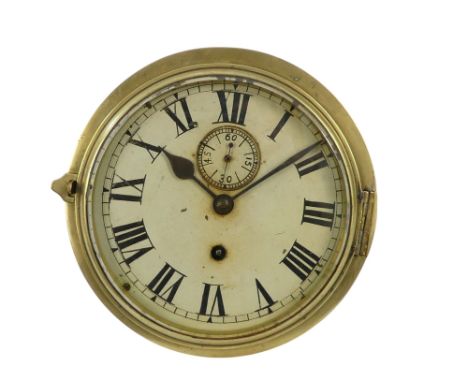An early 20th century brass bulkhead clock - the cream painted dial set out with Roman numerals, 24cm diameter.