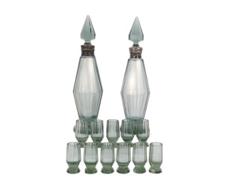 An Art Deco style decanter set - comprising two facetted smoked glass decanters together with eleven shot glasses 