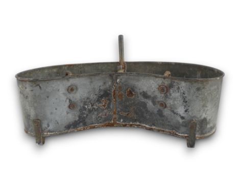 A late 19th century galvanised trough - kidney shaped with an arrangement of hooks and handles, 62cm wide.