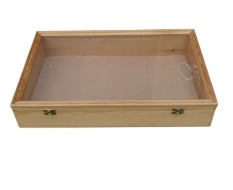 A 20th century pine table top display cabinet - with a glazed hinged cover, 32 x 52 x 12cm.