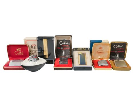 A Colibri pocket lighter - of rectangular form with chrome engine turned finish, boxed with outer packaging, together with fi