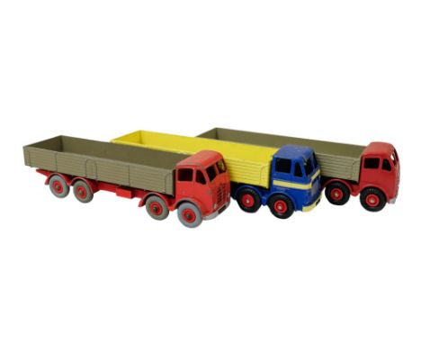 A Dinky Supertoys Foden drop-side truck - red and grey, together with a similar later example and a Layland Octopus. (3)