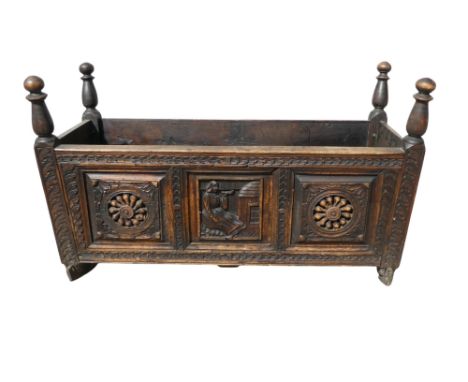 A 17th century style oak coffer - with turned ends and carved panels, 100 x 47 x 58cm.