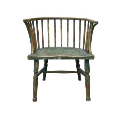 A 19th century Windsor chair - with a distressed green painted finish, the hoop back with turned supports above a contoured s