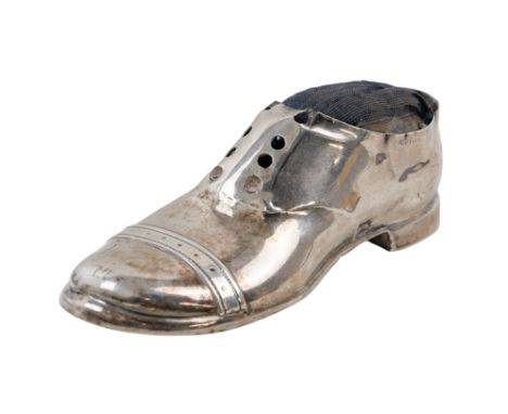A silver pin cushion modelled as a gentleman's shoe - hallmarks indistinct, length 12cm.