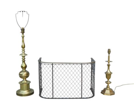A Victorian brass and steel nursery fender - D-shaped, 61cm wide, together with two brass table lamps. (3)