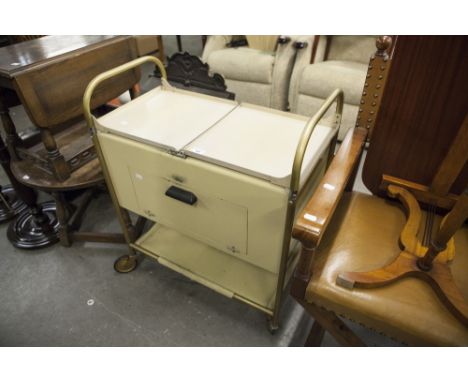 AN EARLY 1960'S CREAM ENAMEL AND GILT TUBULAR METAL HEATED FOOD TROLLEY, WITH ORIGINAL LIDDED DISHES 
