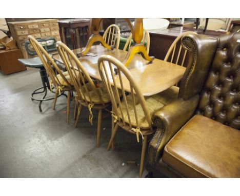 A SET OF LIGHT ELM ERCOL FURNITURE, VIZ A DROP-LEAF TABLE AND SIX STICK BACK CHAIRS 