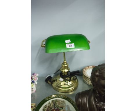BRASS DESK LAMP WITH GREEN OPAQUE GLASS AND ADJUSTABLE OBLONG SHADE AND A DOMED CIRCULAR BASE 
