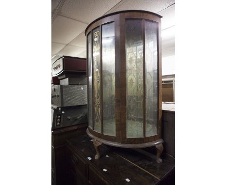 A MID TWENTIETH CENTURY OAK DEMI LUNE DISPLAY CABINET GLASS PANELS THROUGHOUT WITH GILT DECORATION, MIRRORED BACK ON CABRIOLE