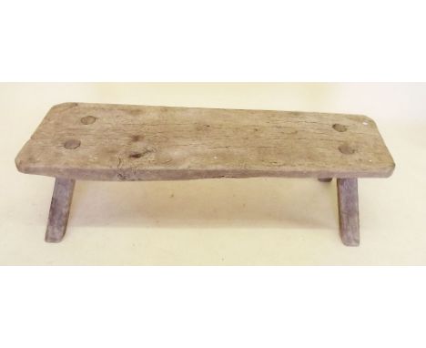 An antique pig bench, 125cm long