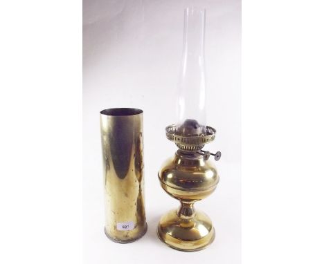 A brass oil lamp and a shell case