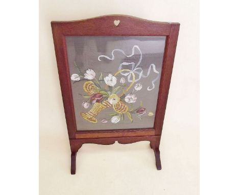 An oak framed floral painted firescreen