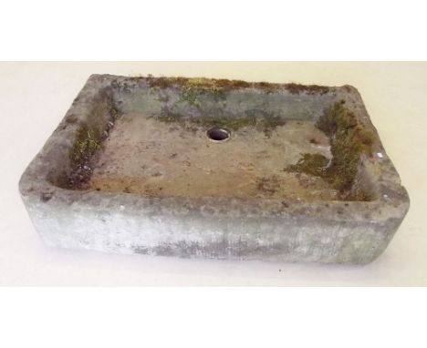 An antique shallow stone trough or sink with plug hole