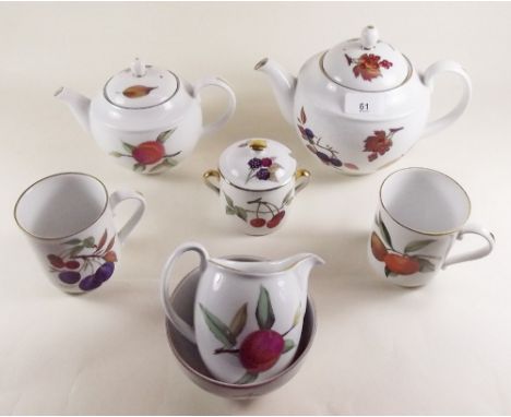 A Royal Worcester Evesham tea service comprising two teapots, milk, sugar, six tea plates, eight cups and a preserve pot