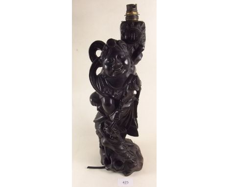 An early 20th century carved wood figure of a deity with lion, converted to a lamp base 38cm