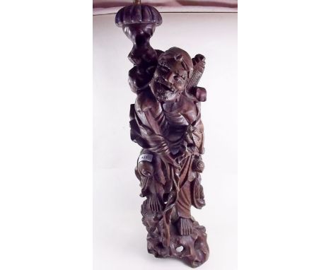 A Chinese carved wood figure of an immortal converted to a table lamp, 64cm