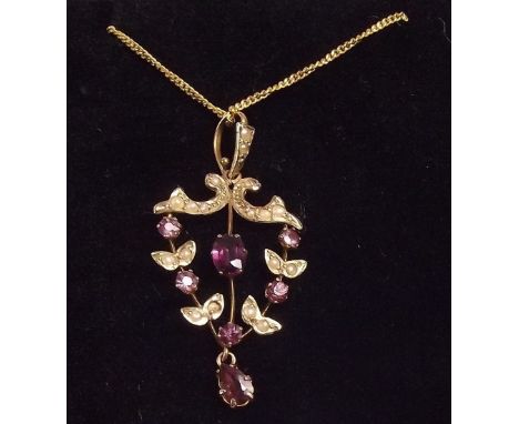 An Edwardian 9 carat gold pendant set amethysts and seed pearls on gold plated chain