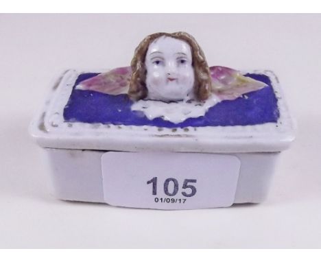 A Victorian small porcelain trinket box with winged cherub head lid - 7cm