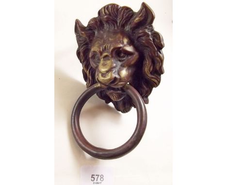 A brass lion door knocker