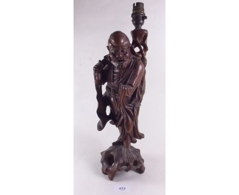 A Chinese carved wood figure of an immortal - converted to a table lamp 43cms