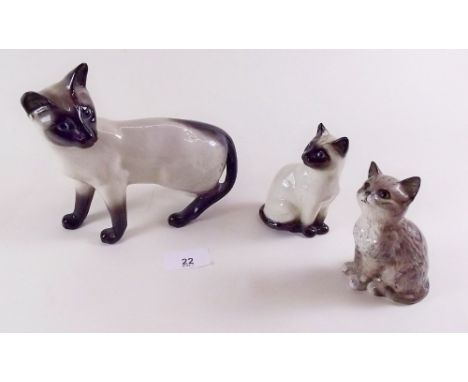 A large Beswick Siamese cat, smaller Siamese and one other Beswick cat