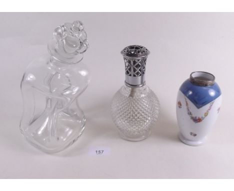 A small moulded glass spirit lamp marked Lampe Berger, a novelty crooked glass four section decanter and a silver rimmed vase