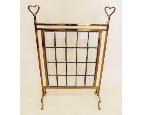 An Edwardian glass and brass firescreen with heart form  finials