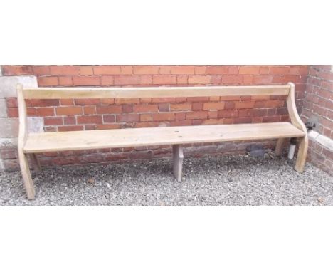 A hand made long carved pine bench on curved end supports - 260cm